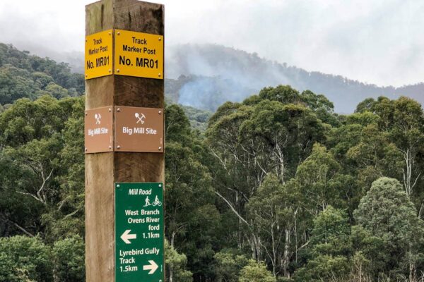 Harrietville Walking trail signs pictured beneath the mountains